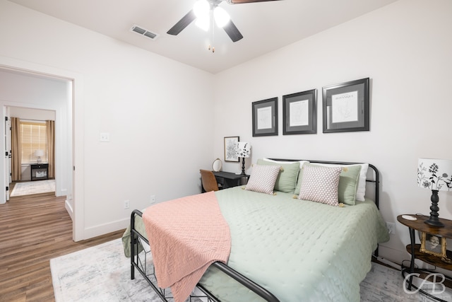 bedroom with ceiling fan and hardwood / wood-style flooring