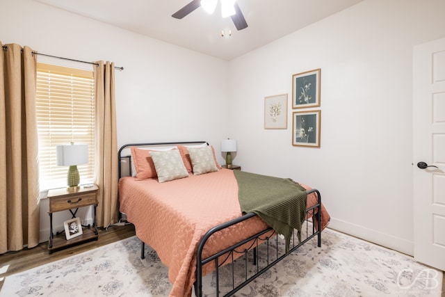 bedroom with ceiling fan and wood-type flooring