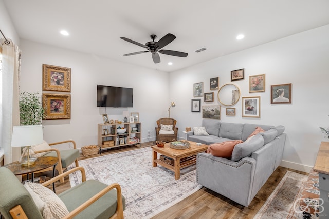 living room with hardwood / wood-style floors and ceiling fan