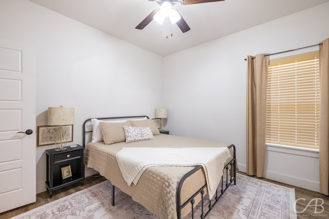 bedroom featuring wood-type flooring and ceiling fan