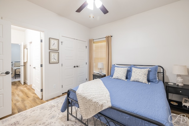 bedroom featuring ceiling fan, a closet, and hardwood / wood-style floors