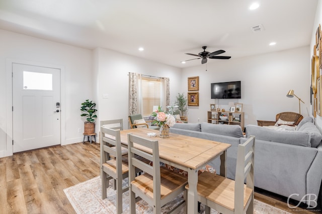 dining space featuring light hardwood / wood-style floors and ceiling fan