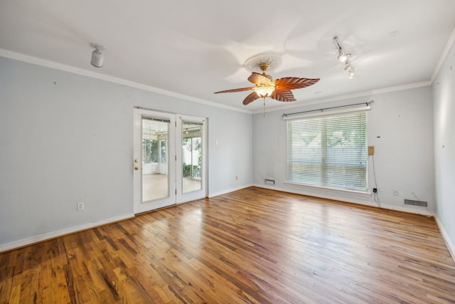 empty room with ceiling fan, hardwood / wood-style flooring, and ornamental molding