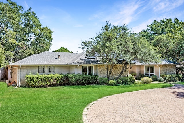 ranch-style house with a front lawn