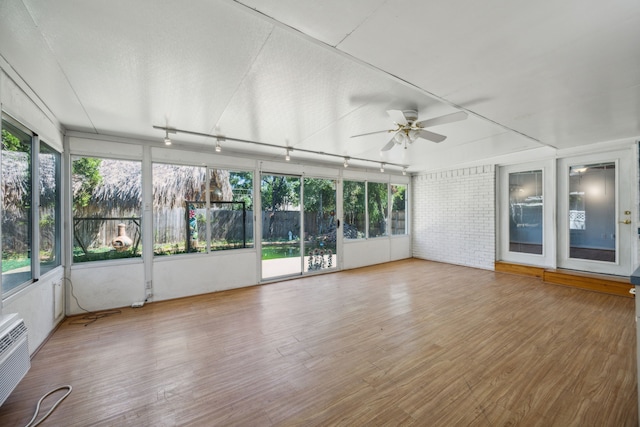 unfurnished sunroom with ceiling fan and a healthy amount of sunlight