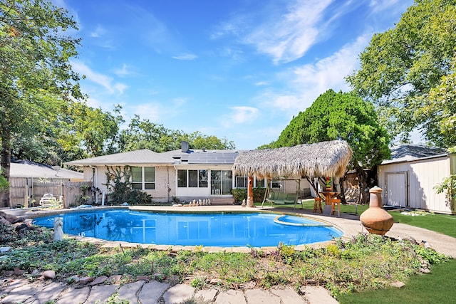 view of pool featuring a storage unit, a patio, and a gazebo