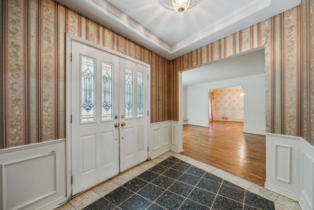 entrance foyer featuring a tray ceiling and hardwood / wood-style floors