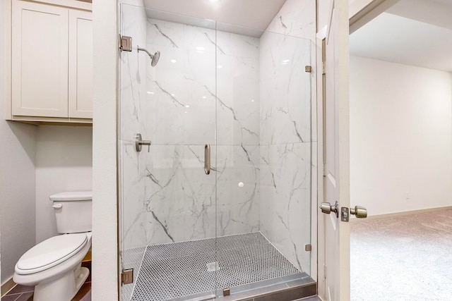 bathroom featuring walk in shower and toilet