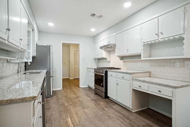 kitchen featuring light hardwood / wood-style flooring, white cabinets, and gas stove