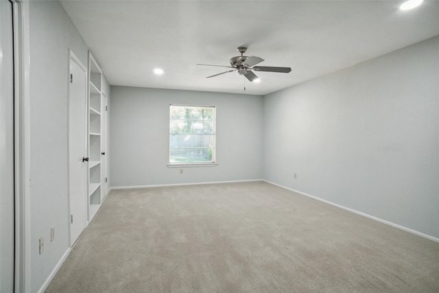 empty room with light carpet and ceiling fan