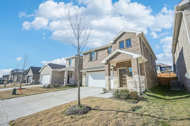 view of front of property featuring a garage, a front lawn, and central AC