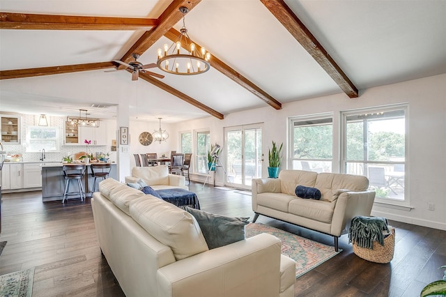 living room with a wealth of natural light, vaulted ceiling with beams, and dark hardwood / wood-style flooring