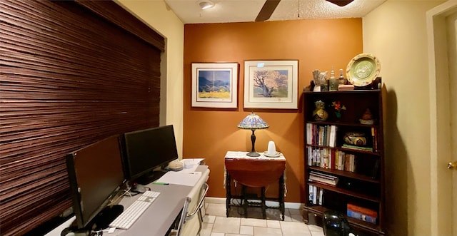 tiled home office with ceiling fan and a textured ceiling