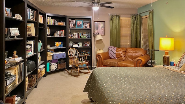 bedroom featuring ceiling fan, light colored carpet, and a textured ceiling