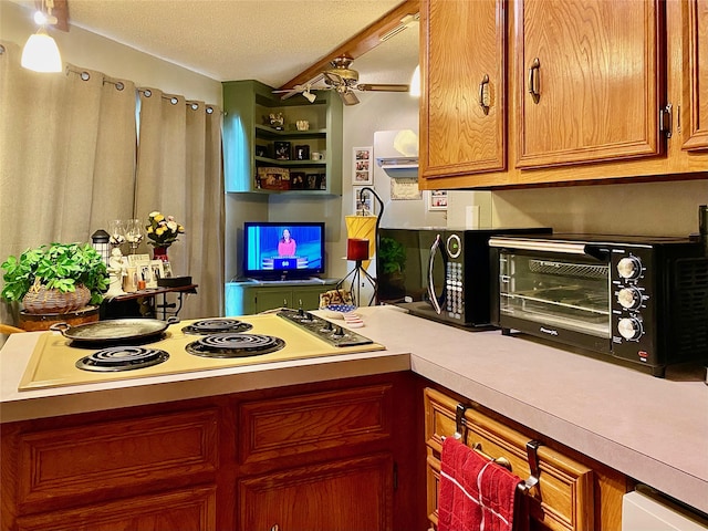 kitchen featuring ceiling fan, white electric cooktop, and a textured ceiling