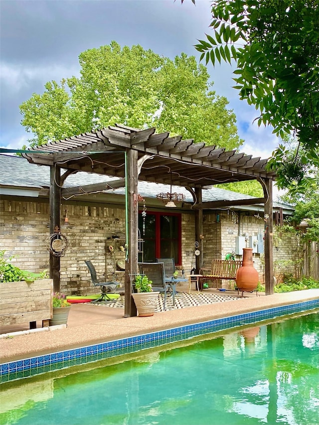 view of pool with a pergola and a patio area