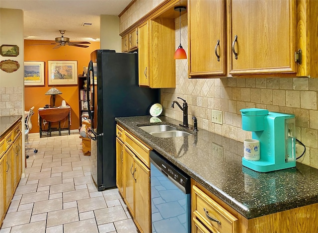 kitchen with decorative backsplash, black refrigerator, ceiling fan, sink, and dishwasher