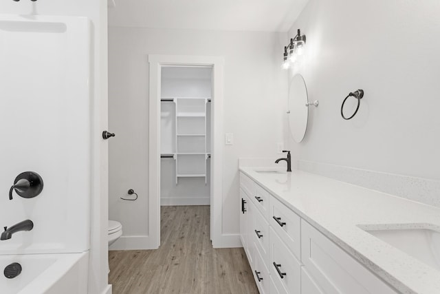 full bathroom with wood-type flooring, vanity, toilet, and separate shower and tub