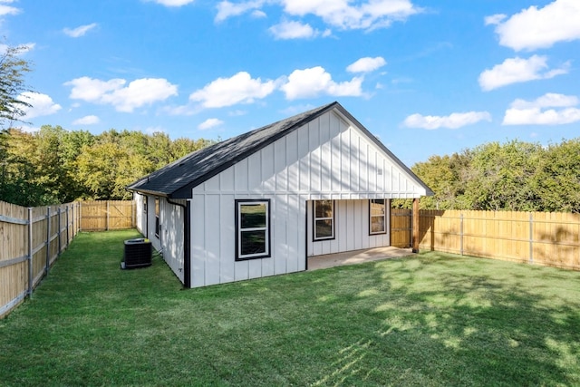 view of outbuilding with a lawn and central AC unit