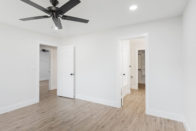 unfurnished bedroom with connected bathroom, ceiling fan, and light hardwood / wood-style flooring