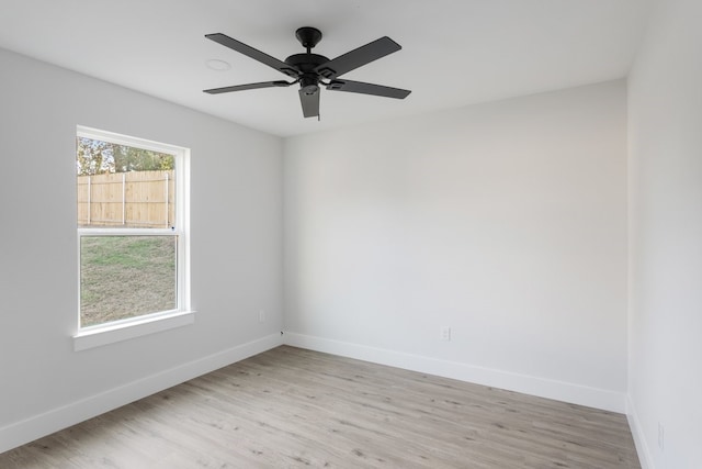 empty room with light wood-type flooring and ceiling fan