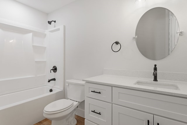 full bathroom featuring hardwood / wood-style floors, vanity, toilet, and bathtub / shower combination