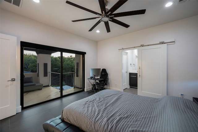 bedroom with ceiling fan, access to exterior, ensuite bathroom, and a barn door