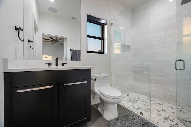 bathroom with vanity, toilet, ceiling fan, and a shower with door