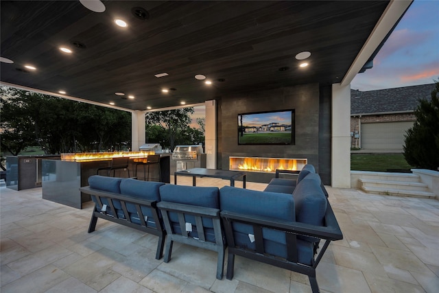 view of patio with an outdoor living space with a fireplace and area for grilling