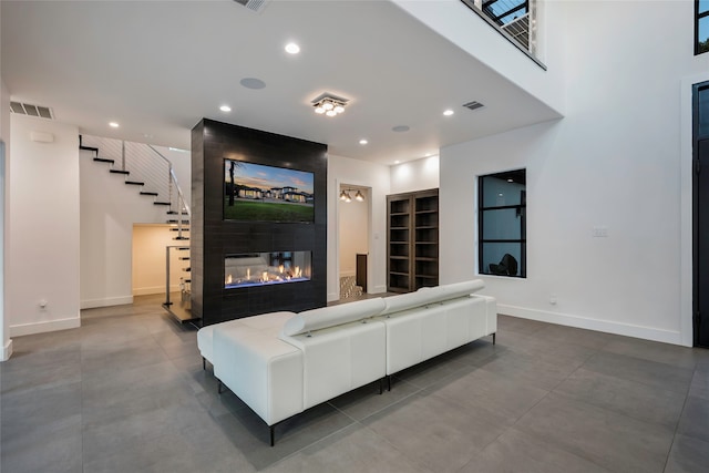 living room with a large fireplace and built in features