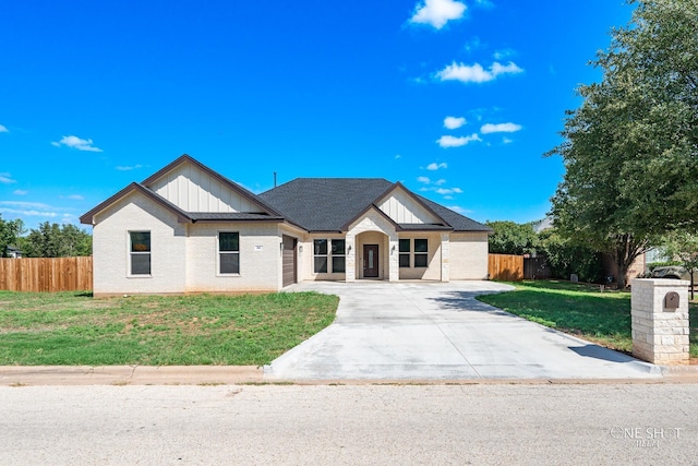 modern inspired farmhouse featuring a front lawn