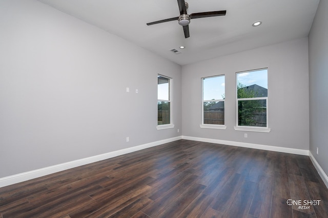 unfurnished room featuring ceiling fan and dark hardwood / wood-style flooring