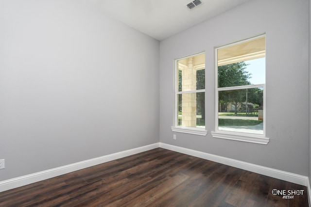 unfurnished room with dark hardwood / wood-style flooring