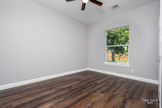 empty room with dark hardwood / wood-style flooring and ceiling fan