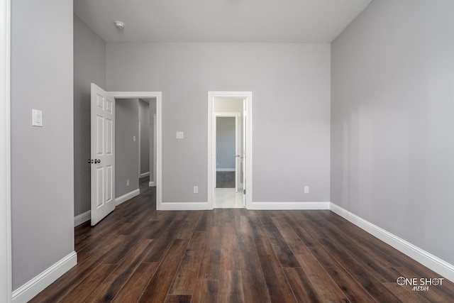 unfurnished bedroom with dark wood-type flooring