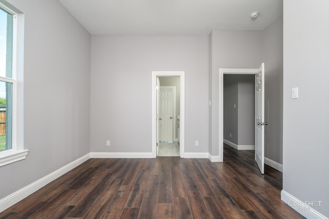 unfurnished bedroom featuring dark hardwood / wood-style floors