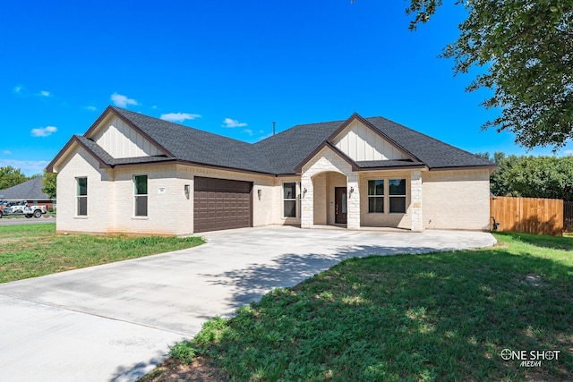 802 Waters Edge Dr, Abilene, TX 79602 - view of front of house with a garage, board and batten siding, fence, and concrete driveway