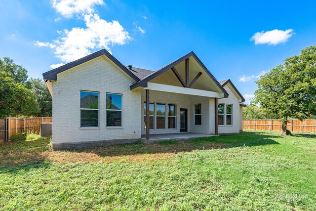 back of house featuring a yard, a patio, and central air condition unit