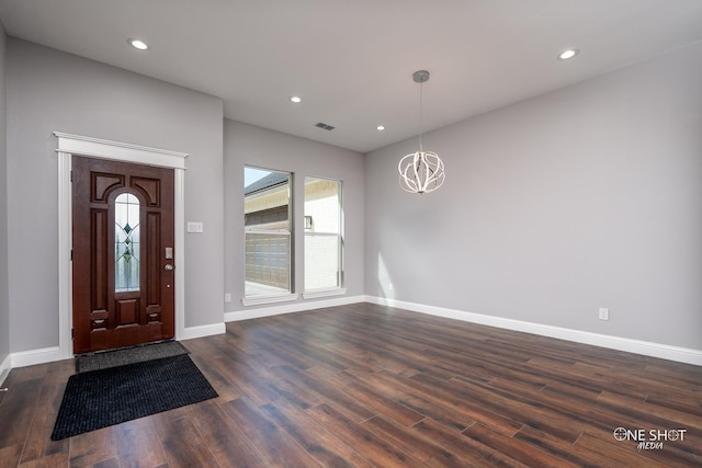 foyer with a chandelier and dark hardwood / wood-style flooring