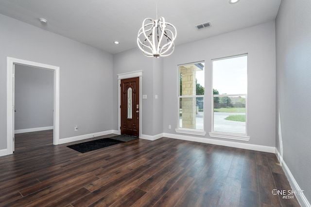 interior space featuring dark hardwood / wood-style flooring, a wealth of natural light, and an inviting chandelier