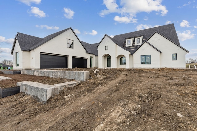 french country style house with a garage