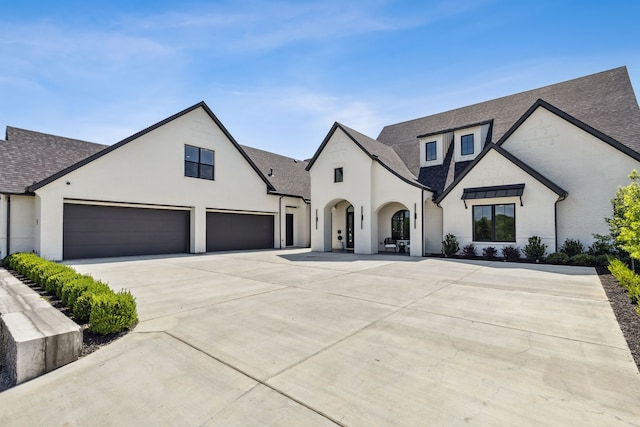1644 Aster Way, Celina, TX 75009 - french country style house with roof with shingles, concrete driveway, stucco siding, and a garage