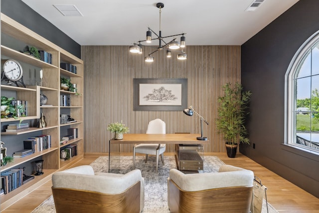 1644 Aster Way, Celina, TX 75009 - home office featuring an accent wall, a chandelier, and wood finished floors