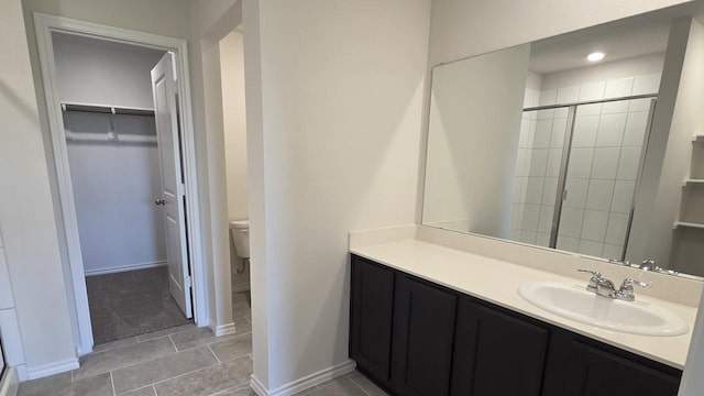 506 Shady Bank Way, Josephine, TX 75173 - full bathroom featuring a shower stall, a walk in closet, toilet, and vanity