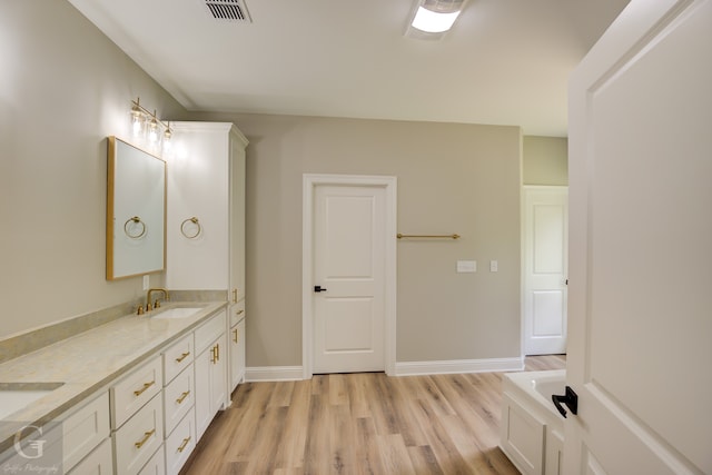 bathroom featuring hardwood / wood-style flooring and vanity