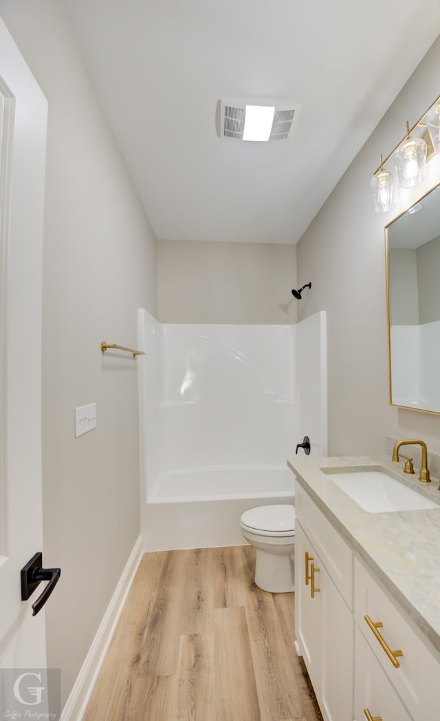 full bathroom with toilet, vanity, shower / bathing tub combination, and hardwood / wood-style flooring