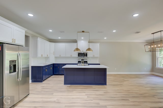 kitchen featuring hanging light fixtures, stainless steel appliances, crown molding, blue cabinetry, and white cabinetry