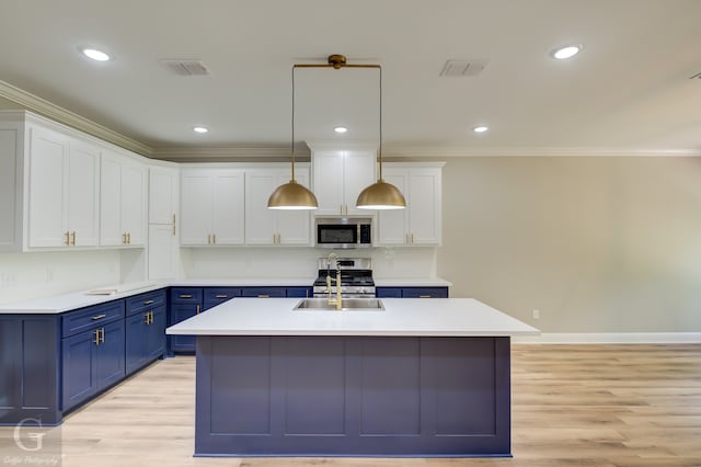 kitchen with light hardwood / wood-style floors, sink, white cabinetry, decorative light fixtures, and blue cabinets