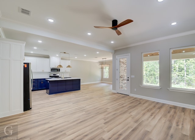 unfurnished living room featuring ceiling fan, a healthy amount of sunlight, crown molding, and light hardwood / wood-style flooring