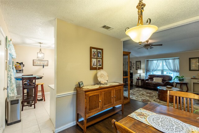 dining area featuring ceiling fan, a textured ceiling, and light hardwood / wood-style flooring